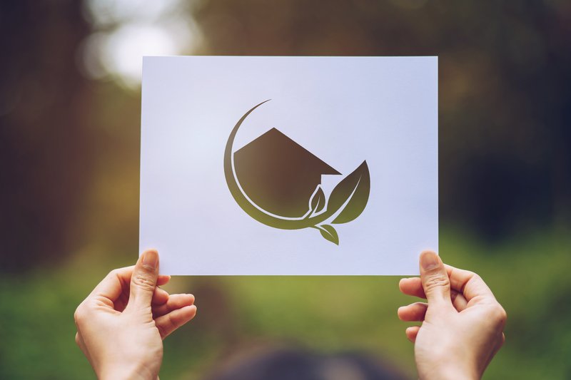 cropped-hands-person-holding-paper-with-model-home-leaf-cut-out