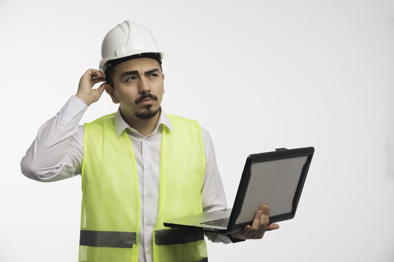 engineer-uniform-holding-laptop-thinking