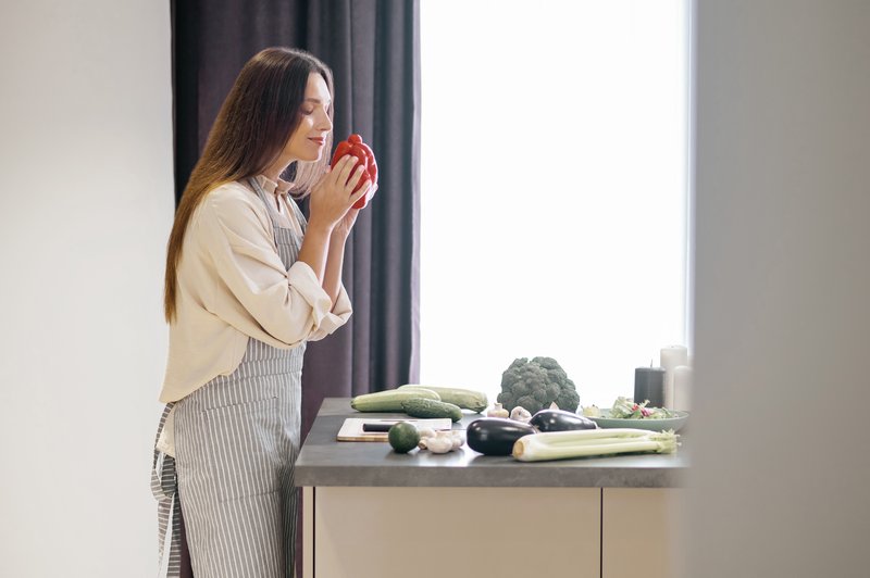 long-haired-young-woman-holding-red-pepper-hands